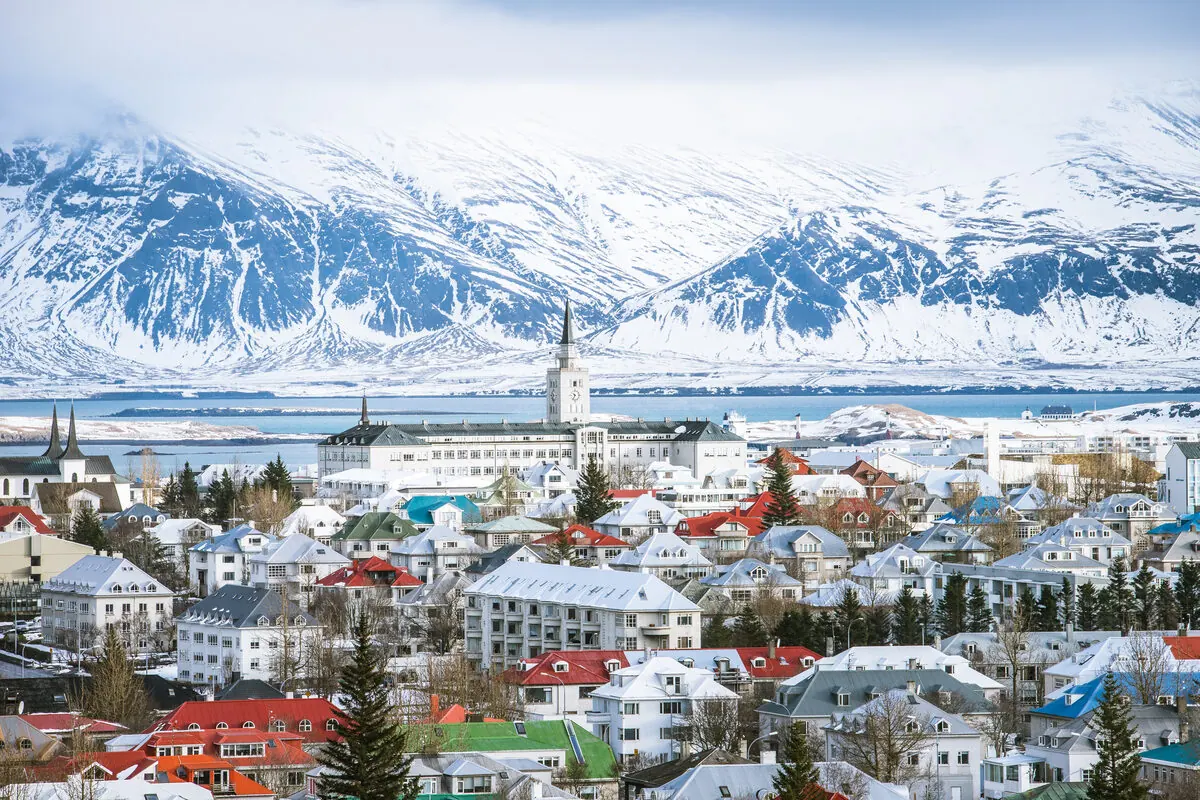 Winter aerial view of Reykjavík with snow-covered mountains behind the city