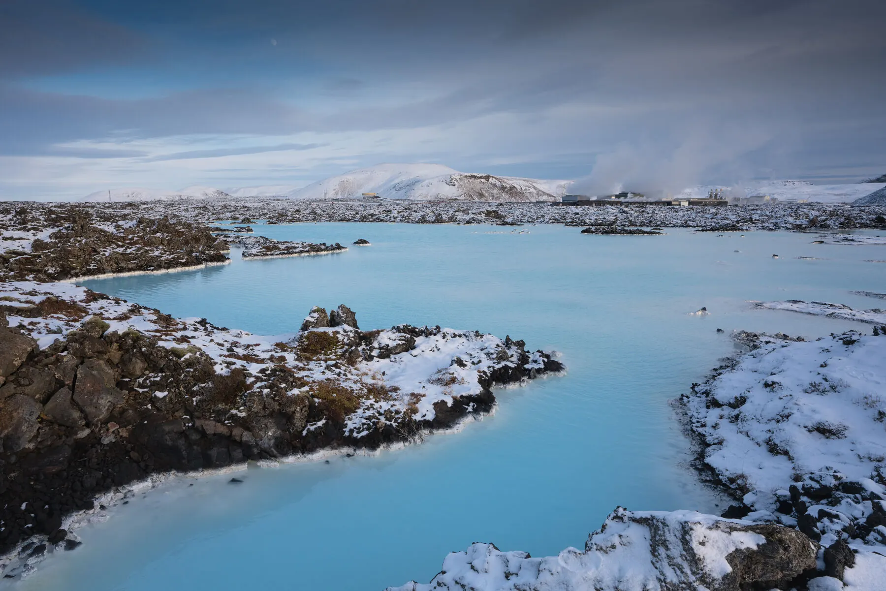 Sunset light over a warm geothermal pool