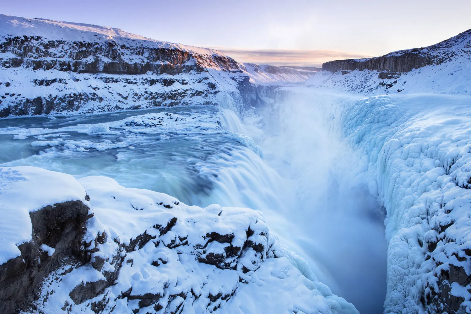 Gullfoss waterfall and canyon coated in snow and ice in winter