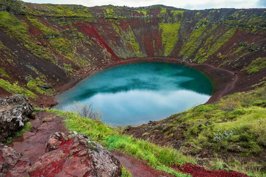 Kerið crater lake with its striking turquoise water and red volcanic slopes