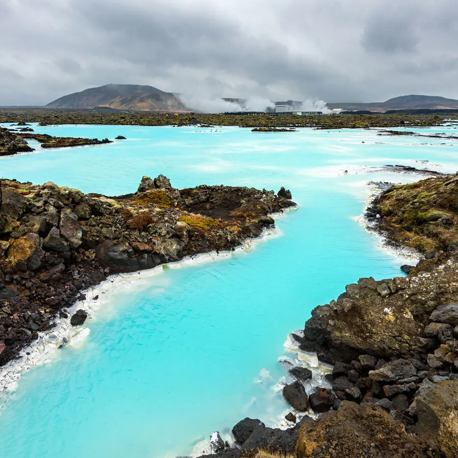 Bathers soaking in warm water surrounded by rocks